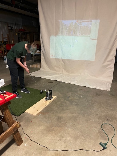 Landon Griffith using golf simulator